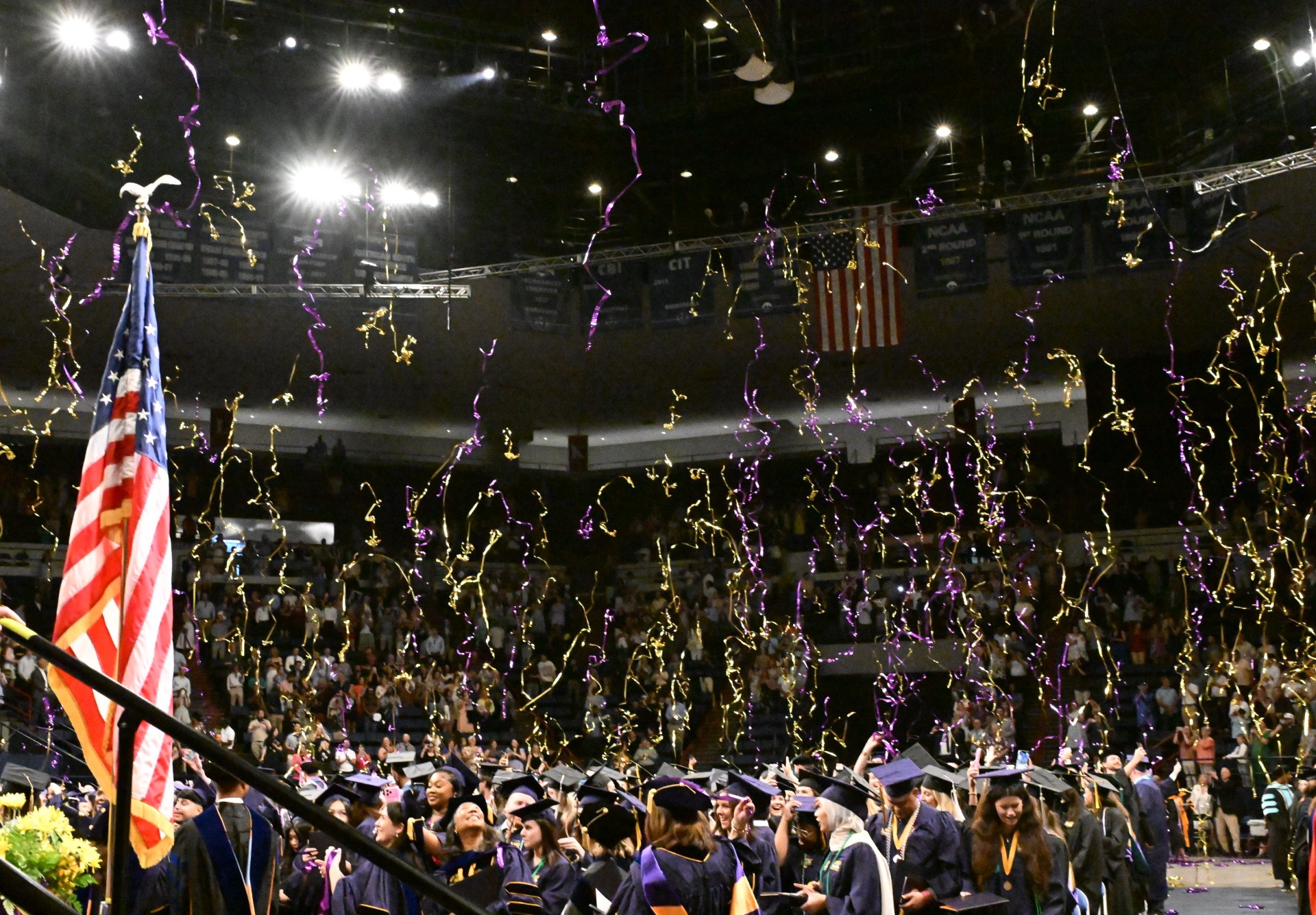 graduates throw their caps in the air