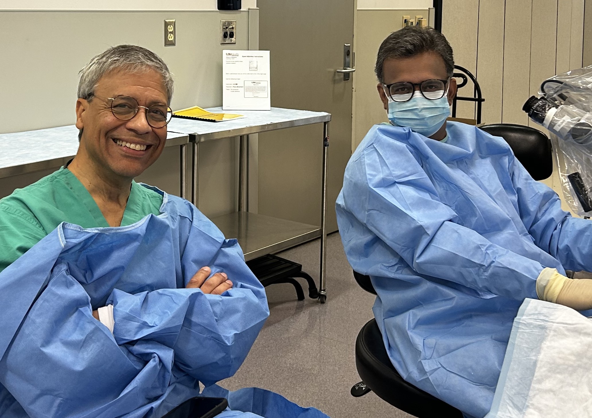 Two faculty in scrubs at the CAP lab