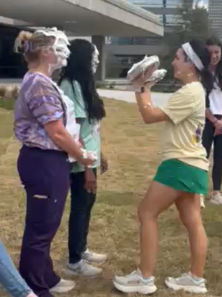 Two students get pied in the face.