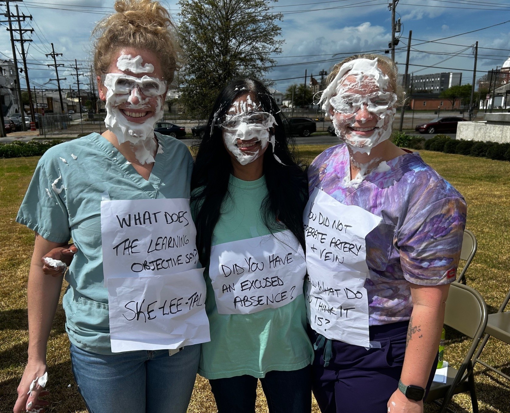 Three volunteers show off their pied faces