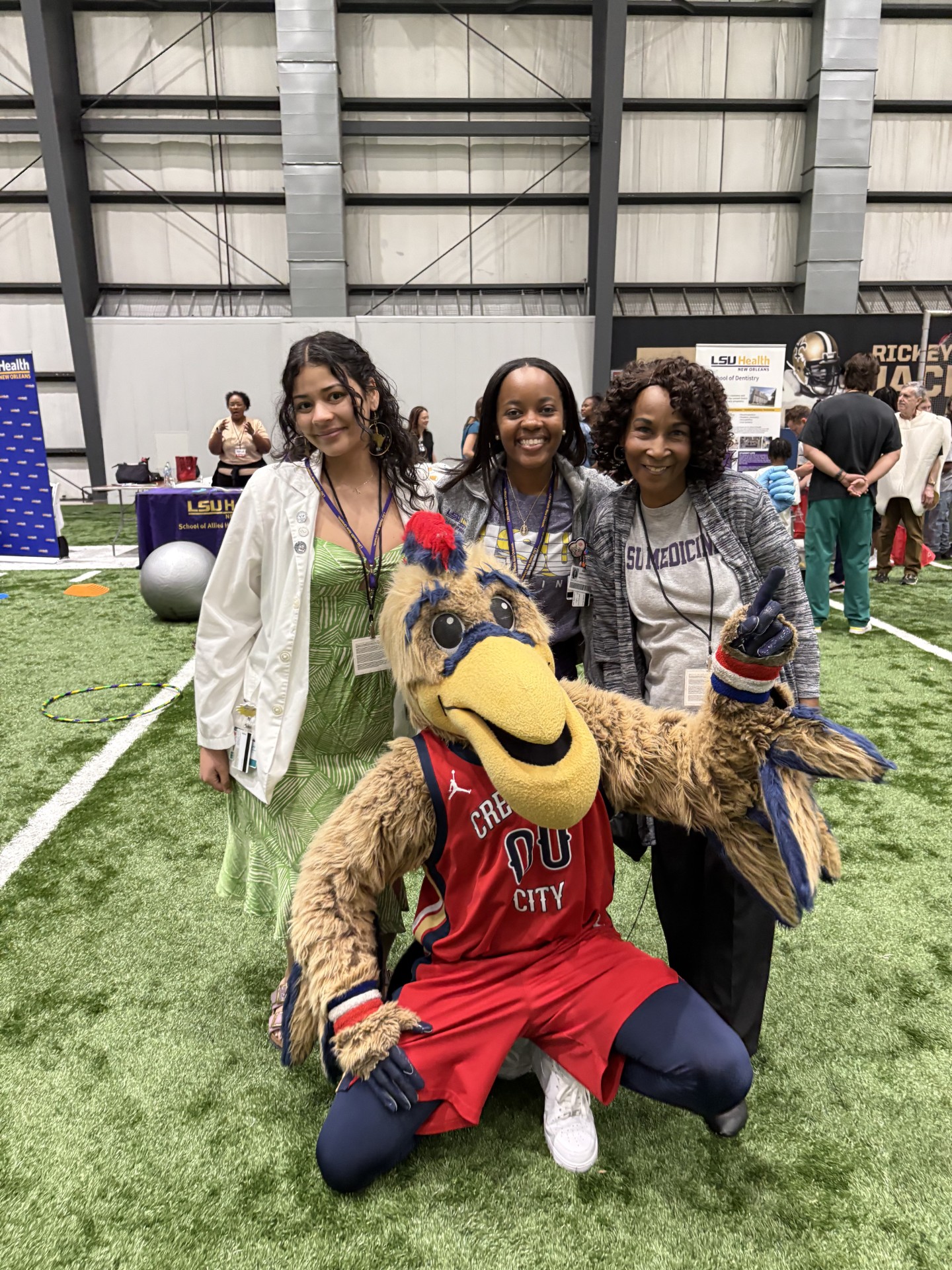 Event volunteers pose with mascot