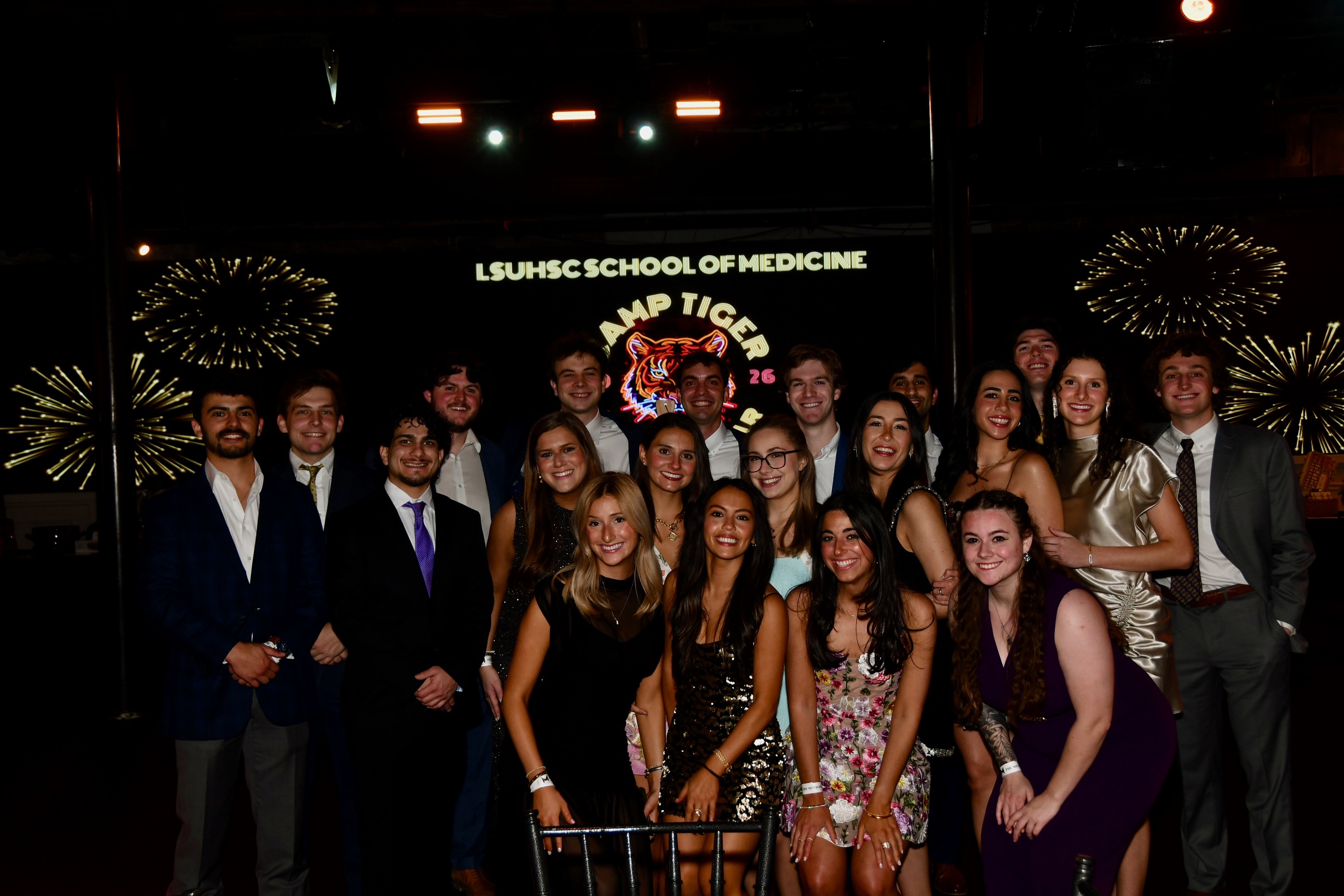 A large group of gala attendees pose for a photograph
